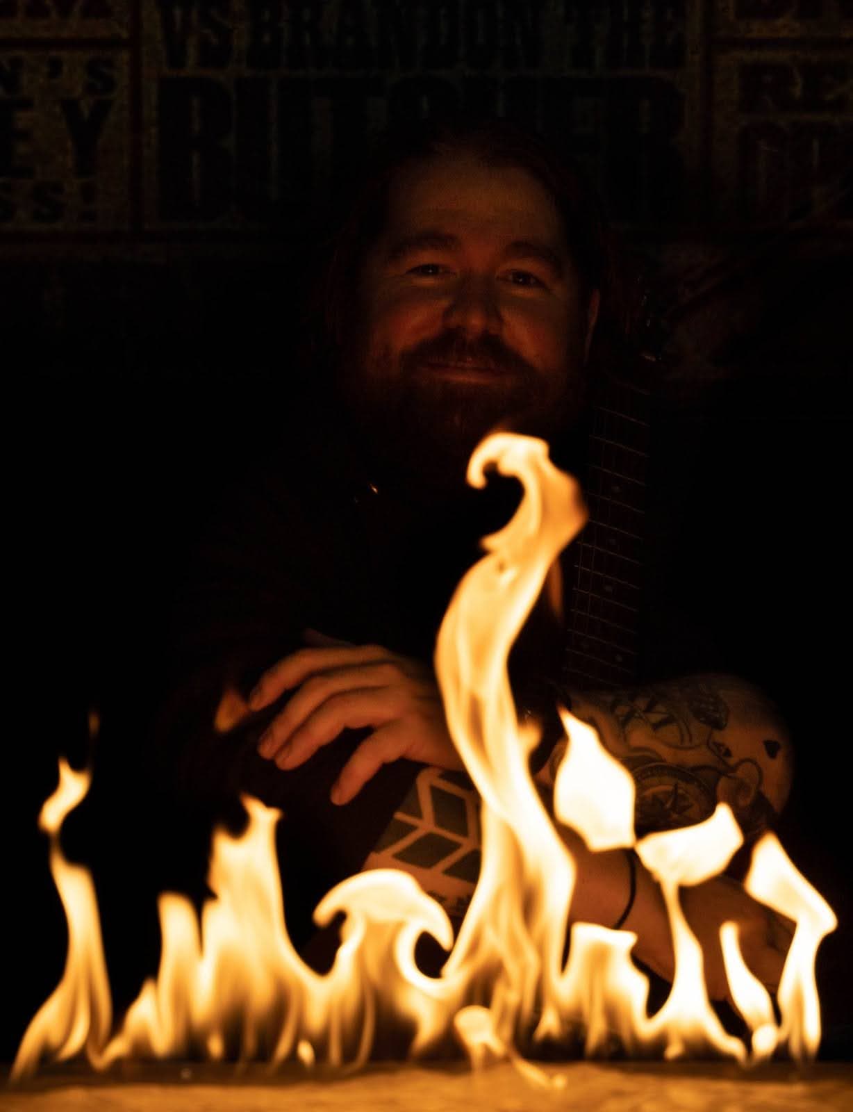 John Mulvey behind a wall of flame